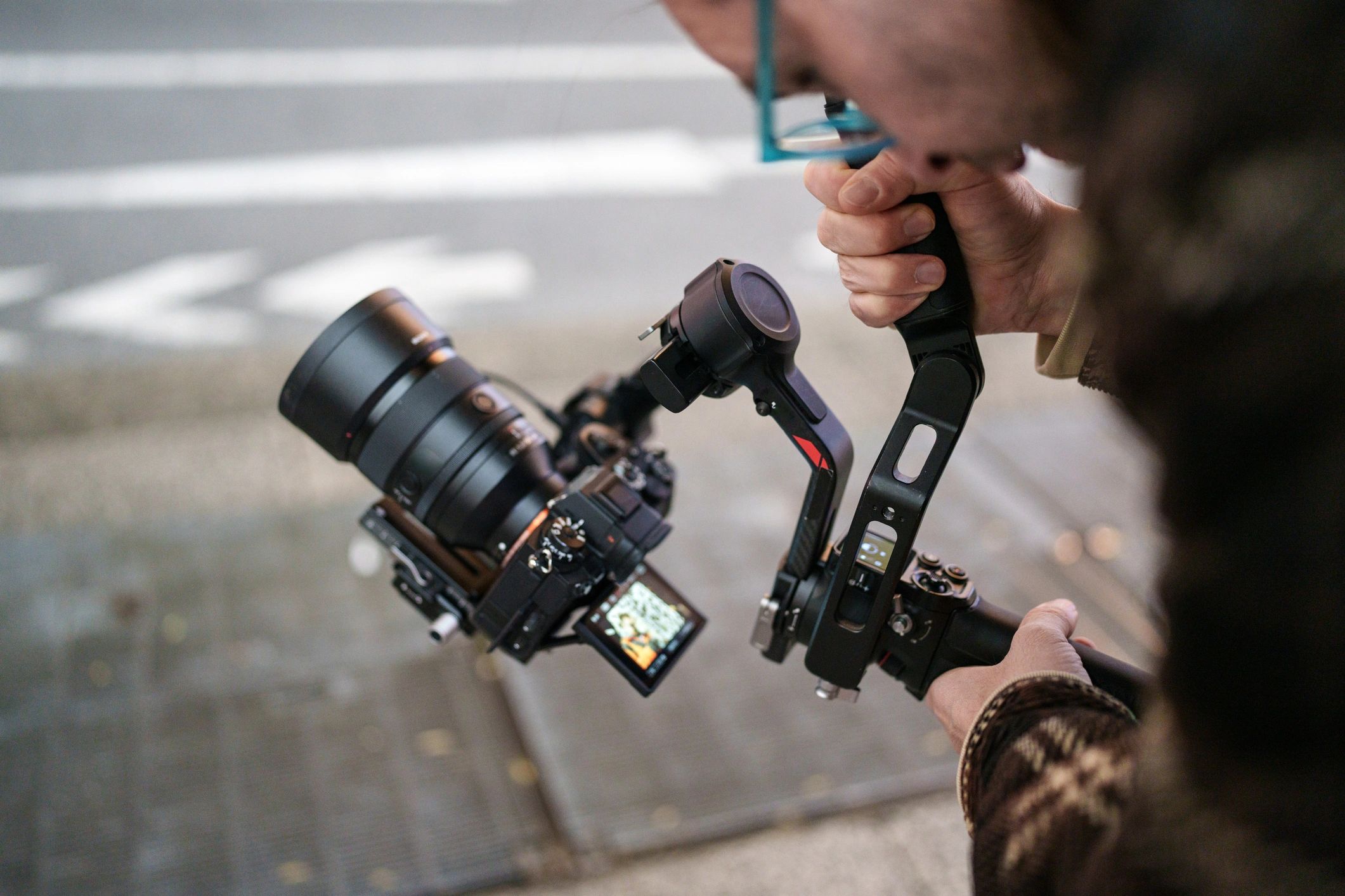 Camera operator filming in a city at night